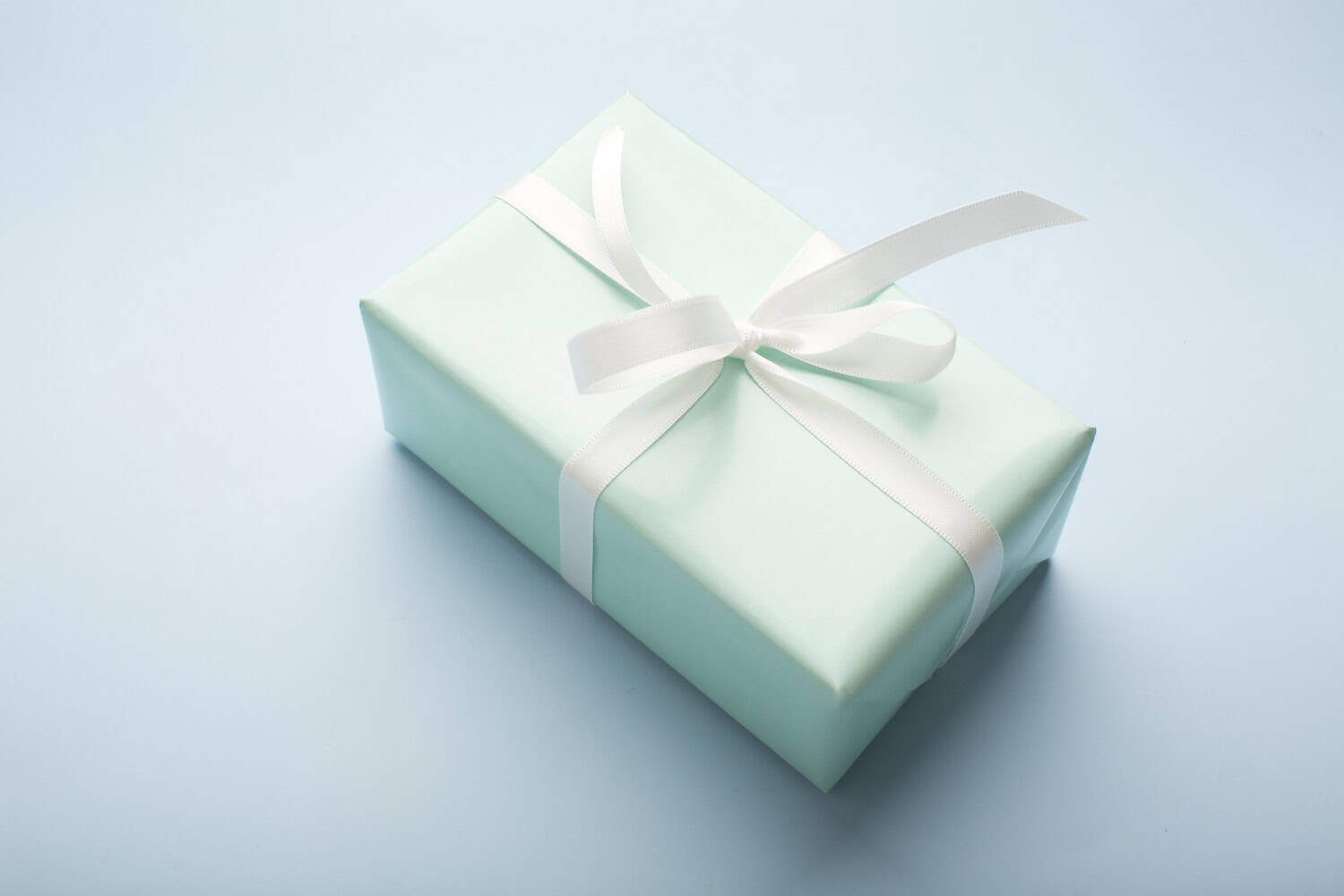 Present boxes on blue background greeting card holidays concept.